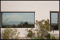 Shrubs, Chisos mountains, Persimmon Gap Visitor Center window reflexion. Big Bend National Park, Texas, USA. (color)