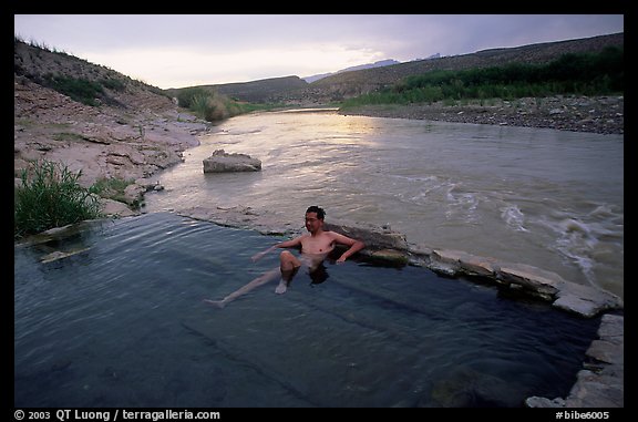 Visitor relaxes in hot springs next to Rio Grande. Big Bend National Park, Texas, USA.