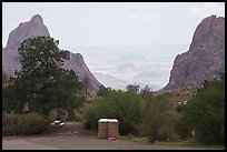 Portable toilets and a picnic table stand at the overlook where the basin opens in a dramatic V-shaped gap to the desert beyond. Big Bend National Park ( color)
