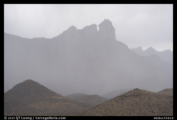 Jagged peaks fade into curtains of rain. Big Bend National Park (color)