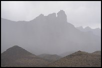 Jagged peaks fade into curtains of rain. Big Bend National Park ( color)