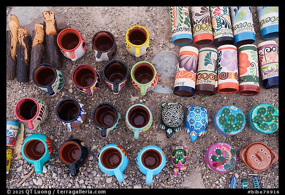Hand-painted mugs, whistles, and small animals form a tight grid of color, each piece stamped with the name of Boquillas. Big Bend National Park (color)
