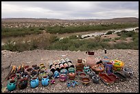 Rows of colorful ceramic mugs, bowls, and figurines line the edge of a bluff. Big Bend National Park ( color)