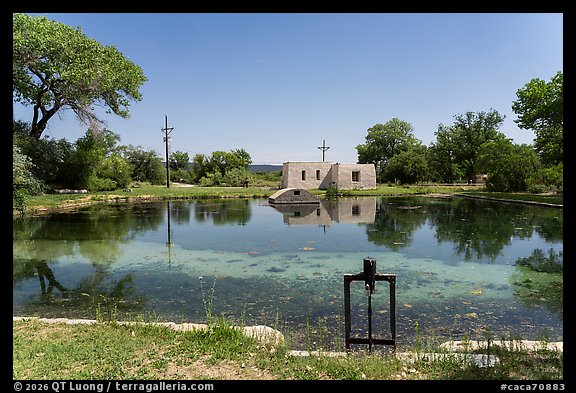 Rattlesnake Springs pond reflecting a historic adobe pumphouse and control structure. Carlsbad Caverns National Park (color)