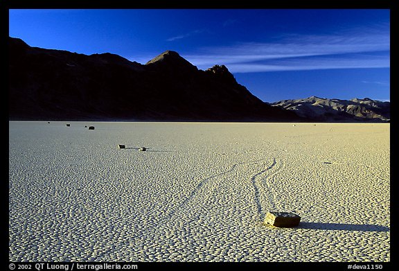 Tracks, moving rock on the Racetrack and Ubehebe Peak, late afternoon. Death Valley National Park, California, USA.