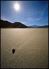 Tracks and moving rock on the Racetrack, mid-day. Death Valley National Park, California, USA.