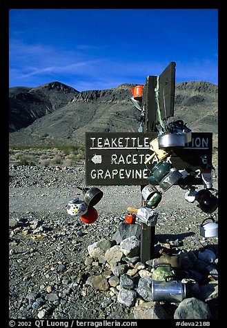 Teakettle Junction sign, adorned with teakettles. Death Valley National Park (color)