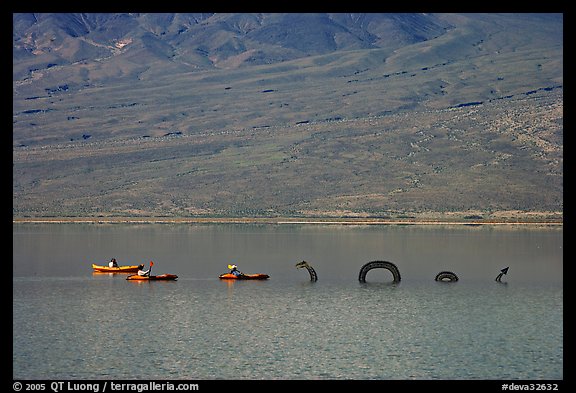 Kayakers approaching the dragon in the rare Manly Lake. Death Valley National Park (color)