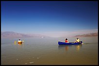 Canoists and kayaker on the flooded floor. Death Valley National Park, California, USA. (color)
