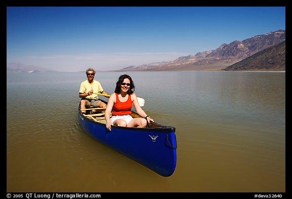 Canoists in rarely formed Manly Lake with Black Mountains in the background. Death Valley National Park (color)