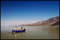 Canoeing on the ephemerald Manly Lake with Black Mountains in the background. Death Valley National Park, California, USA.