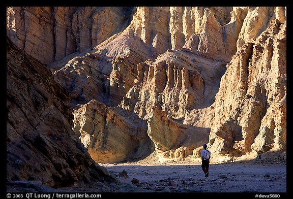 Hikers surrounded by tall walls in Golden Canyon. Death Valley National Park (color)
