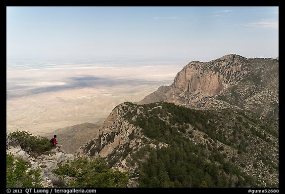 Hiker surveying view over mountains and plains. Guadalupe Mountains National Park, Texas, USA.