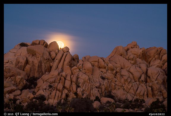 Moonset over rocks delimiting Hidden Valley. Joshua Tree National Park, California, USA.
