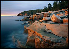 Granite slabs and Otter Point at sunrise. Acadia National Park, Maine, USA.