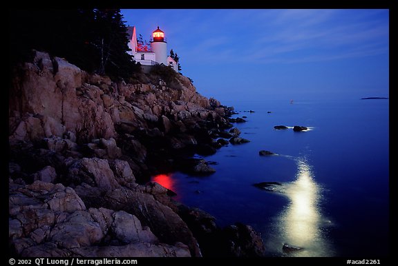 Bass Harbor lighthouse by night with moon reflection in ocean. Acadia National Park, Maine, USA.