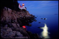 Bass Harbor lighthouse by night with moon reflection in ocean. Acadia National Park, Maine, USA.