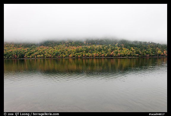 Hill reflected in Jordan Pond with top covered by fog. Acadia National Park, Maine, USA.