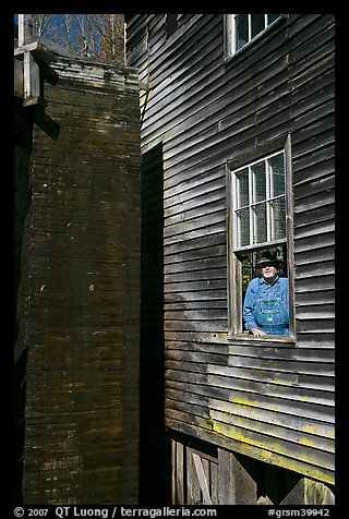 Miller standing at window, Mingus Mill, North Carolina. Great Smoky Mountains National Park, USA.