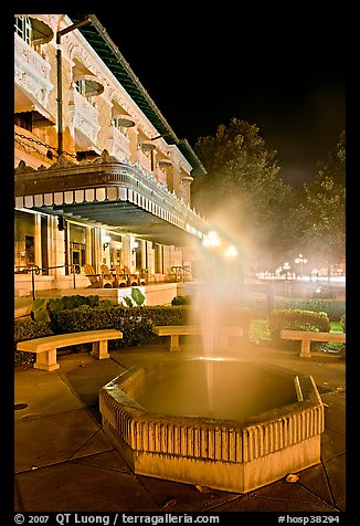 Fountain with thermal steam outside Fordyce Bath at night. Hot Springs National Park, Arkansas, USA.