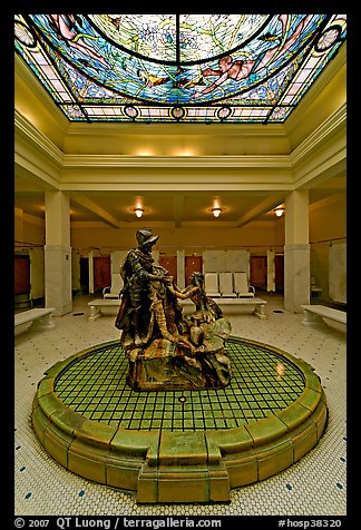 Statue of Desoto receiving gift from Caddo Indian maiden in mens bath hall. Hot Springs National Park (color)