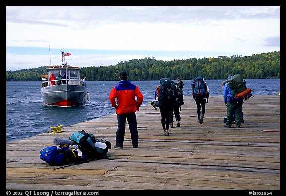 Backpackers waiting for pick-up by the ferry at Windego. Isle Royale National Park, Michigan, USA.