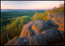 Mount Franklin granite outcrop and distant Lake Superior at sunset. Isle Royale National Park, Michigan, USA.
