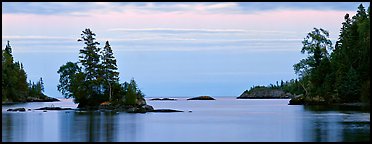 Tree-covered islet at dawn. Isle Royale National Park (Panoramic color)