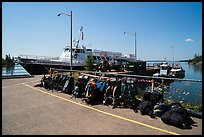 Backpacks lined up on dock, Rock Harbor. Isle Royale National Park ( color)