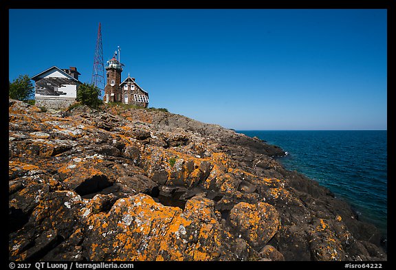 Lichen-covered rocks and Lighthouse, Passage Island. Isle Royale National Park (color)