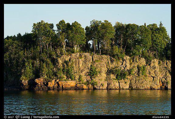 Sea cliffs and trees, late afternoon. Isle Royale National Park, Michigan, USA.