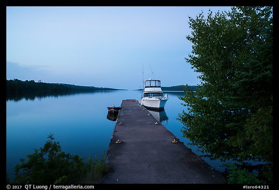 Moskey Basin dock with motorboat and ycaht, dusk. Isle Royale National Park, Michigan, USA.