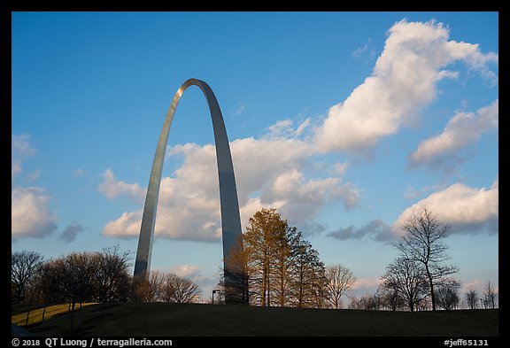 Arch, trees and clouds, winter late afternoon. Gateway Arch National Park, St Louis, Missouri, USA.