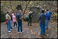 Ranger pointing to cave entrance to tourists. Mammoth Cave National Park, Kentucky, USA.