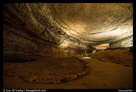 Visitors walk down huge corridor in cave. Mammoth Cave National Park, Kentucky, USA.