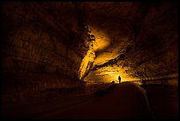 Ranger with lantern backlighted in dark cave corridor. Mammoth Cave National Park ( color)