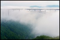 New River Gorge Bridge rising from low fog at dawn. New River Gorge National Park and Preserve ( color)