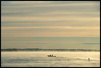 Boaters in fog, early morning, Kabetogama Lake. Voyageurs National Park, Minnesota, USA.