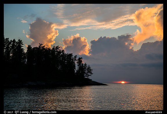 Sun setting below cloud, Rainy Lake. Voyageurs National Park, Minnesota, USA.