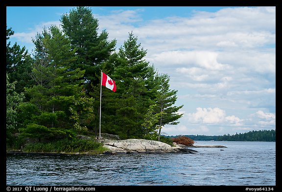 Islet with Canadian flag, Namakan Lake. Voyageurs National Park, Minnesota, USA.