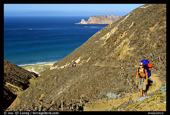 Backpacker going up Nidever canyon trail, San Miguel Island. Channel Islands National Park, California, USA.