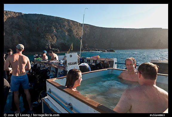 Divers relaxing in hot tub aboard the Spectre and Annacapa Island. Channel Islands National Park (color)