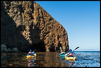 Kayakers paddling in kelp at base of sea cliff, Santa Cruz Island. Channel Islands National Park ( color)