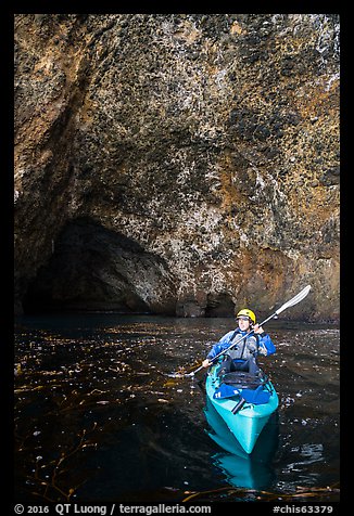 Kayaker near sea cave entrance, Santa Cruz Island. Channel Islands National Park (color)