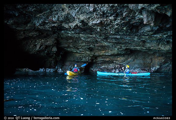 Two kayakers in sea cave with low ceiling, Santa Cruz Island. Channel Islands National Park (color)
