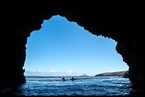 Looking out sea cave entrance with distant sea kayakers, Santa Cruz Island. Channel Islands National Park ( color)
