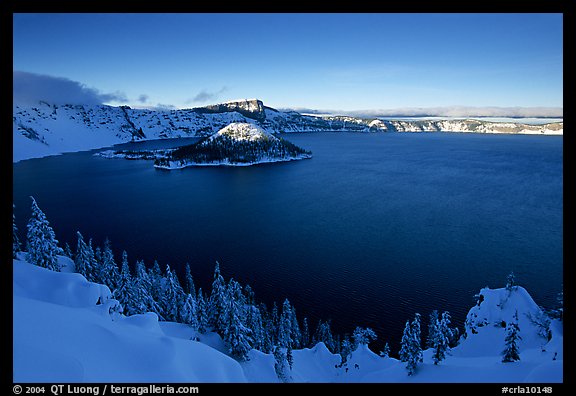 Wizard Island and lake in late afternoon shade, winter. Crater Lake National Park, Oregon, USA.