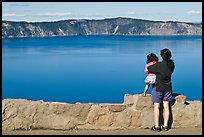 Woman and baby looking at Crater Lake. Crater Lake National Park, Oregon, USA. (color)