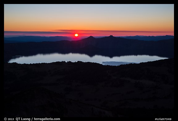 Wide view from Mount Scott of sun setting over Crater Lake. Crater Lake National Park, Oregon, USA.