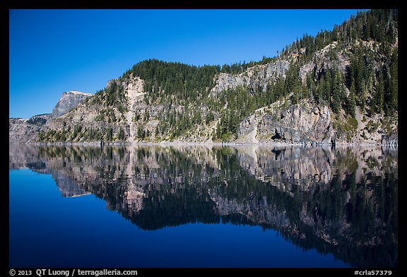 Cliffs reflected in calm waters. Crater Lake National Park, Oregon, USA.